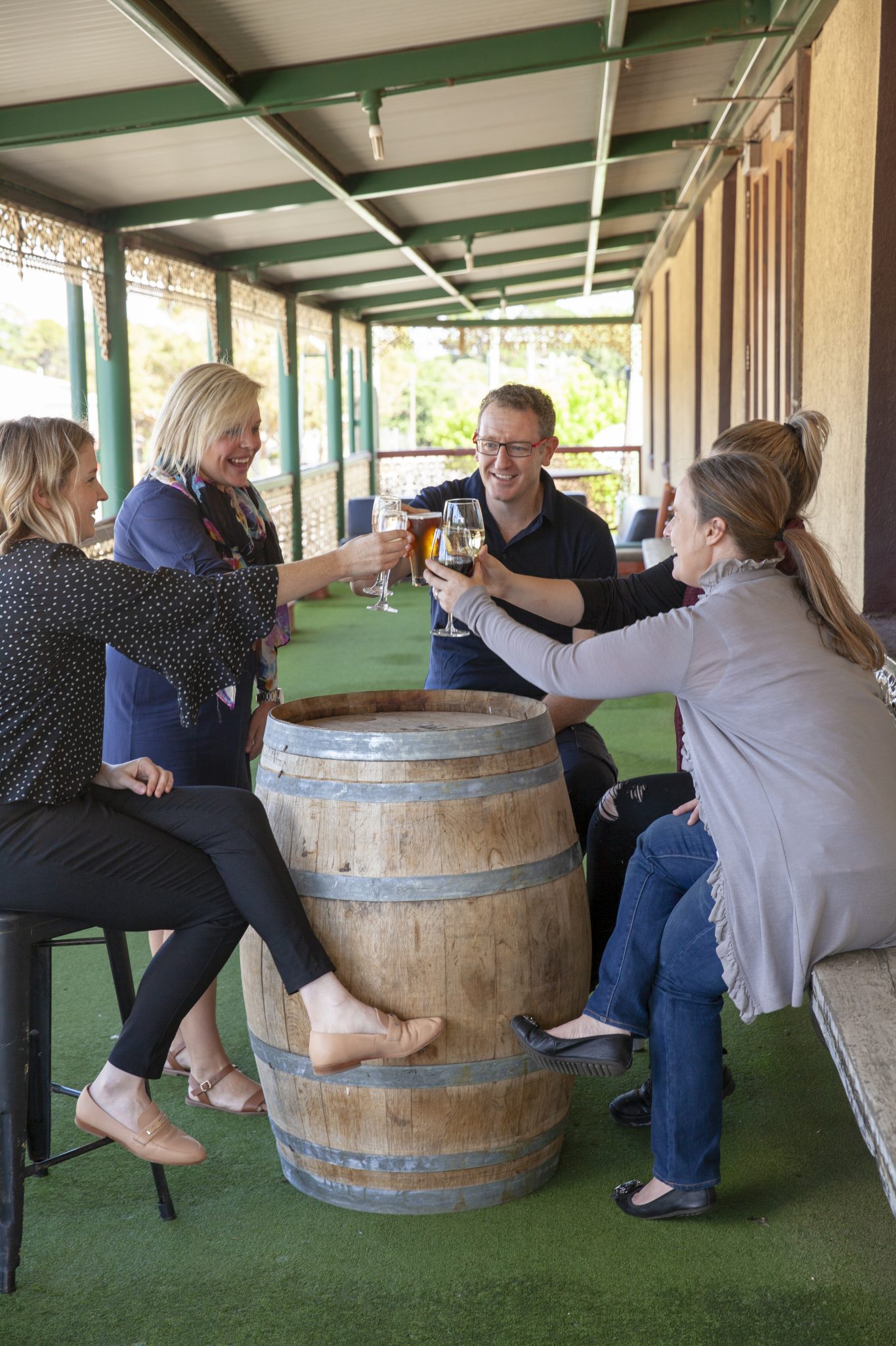 The Mountain View Room balcony - Expansive balcony with seating overlooking Mount Macedon, providing a relaxing breakout space for fresh air, informal chats, and small group discussions. People socializing, having wine and beer.